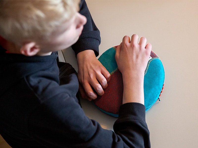 boy on sofa with sleeping with interactive music cushion