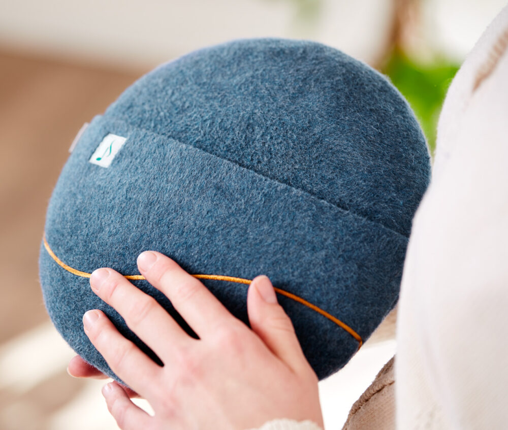 Woman holding inmuRELAX sensory tool with music